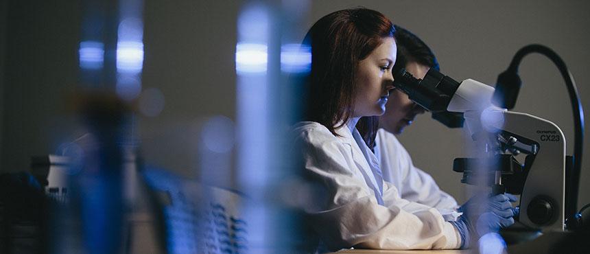 Students looking through microscopes.