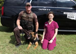 Vet Tech student Cairlin Lewis with a State Trooper and his dog Marko